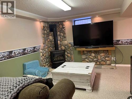 4617 51 Avenue, Taber, AB - Indoor Photo Showing Other Room With Fireplace