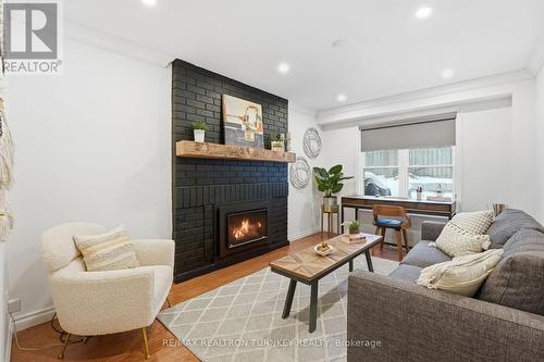 Main-floor bedroom or office option - 196 Orchard Heights Boulevard, Aurora, ON - Indoor Photo Showing Living Room With Fireplace