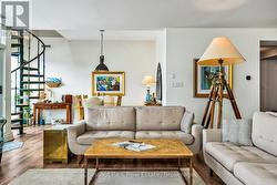 Living rm w/spiral stairs to 2nd floor office - 