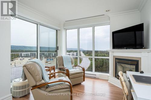 Sitting rm/office in primary bdrm w/gas fireplace - 1001 - 24 Ramblings Way, Collingwood, ON - Indoor Photo Showing Living Room With Fireplace