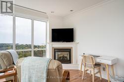 Gas fireplace and office area in primary bedroom - 