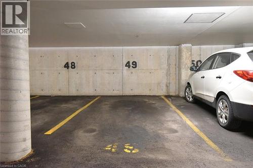 Owned spot in underground parking - 1411 Walkers Line Unit# 202, Burlington, ON - Indoor Photo Showing Garage