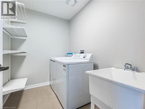Laundry area with washing machine and clothes dryer and light tile patterned flooring - 98 Crafter Crescent, Stoney Creek, ON - Indoor Photo Showing Laundry Room