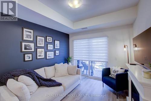 Auto remote blind to patio - #208 - 243 Northfield Drive E, Waterloo, ON - Indoor Photo Showing Living Room
