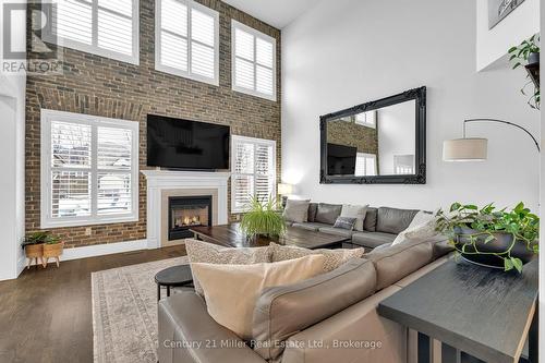 family - 2099 Helmsley Avenue, Oakville (Wm Westmount), ON - Indoor Photo Showing Living Room With Fireplace