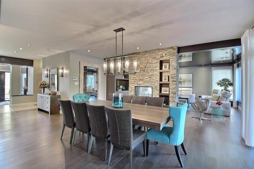 Overall view - 101 Rue Des Cormorans, Val-D'Or, QC - Indoor Photo Showing Dining Room With Fireplace
