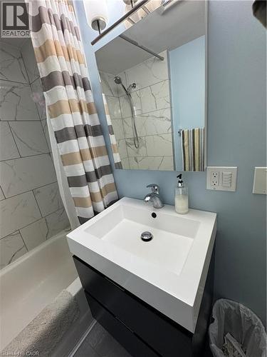 The 2022 bathroom renovation ($9,715.93) adds modern style with subway-tile finishes and a unique peek-a-boo shower window. - 344 Paisley Road, Guelph, ON - Indoor Photo Showing Bathroom
