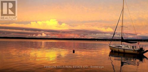 Sunset reflection looking east - 168 Lakebreeze Road, Kawartha Lakes (Fenelon), ON - Outdoor With Body Of Water With View