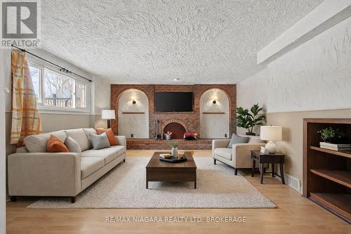 virtually staged - 12 Hampton Court, Welland (Prince Charles), ON - Indoor Photo Showing Living Room With Fireplace