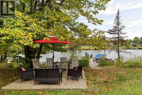 Sitting area and dock - 210 Burnett'S Road, Mckellar, ON - Outdoor With Body Of Water