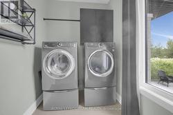 Laundryroom has large window and handy clothes rod - 