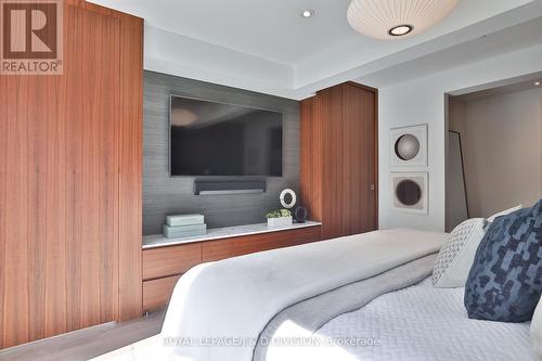 Wall of custom built-ins, concealed walk-in closet - 69 Sullivan Street, Toronto, ON - Indoor Photo Showing Bedroom