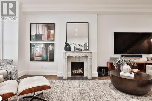 Two gorgeous marble fireplaces flank living space - 69 Sullivan Street, Toronto, ON - Indoor Photo Showing Living Room With Fireplace