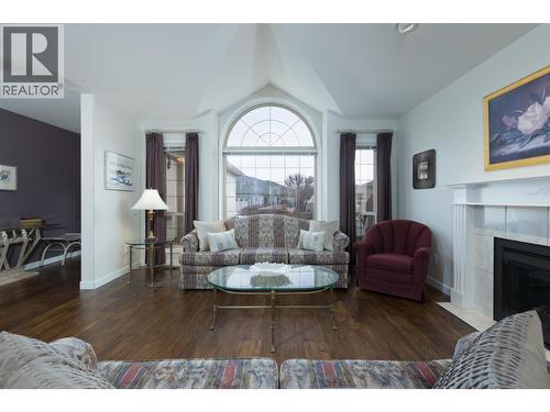 Palladian windows draw in natural light. - 2330 Butt Road Unit# 449, West Kelowna, BC - Indoor Photo Showing Living Room With Fireplace