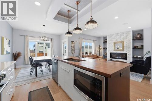 534 Bolstad Turn, Saskatoon, SK - Indoor Photo Showing Kitchen With Fireplace With Double Sink