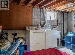Laundry area featuring unfinished concrete floors and independent washer and dryer - 