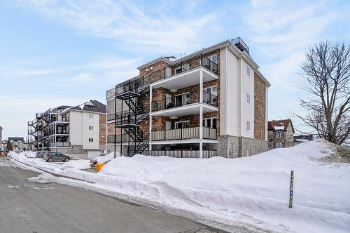 Face arrière - 101-2365 Rue Versailles, Mascouche, QC - Outdoor With Balcony With Facade