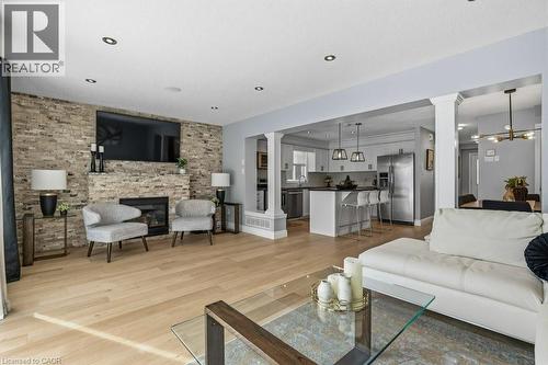 Tons of natural light and room for the whole family - 26 Helena Feasby Street, Kitchener, ON - Indoor Photo Showing Living Room With Fireplace