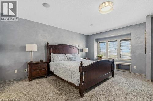 Impressive primary bedroom with walk-in closet and private ensuite - 26 Helena Feasby Street, Kitchener, ON - Indoor Photo Showing Bedroom