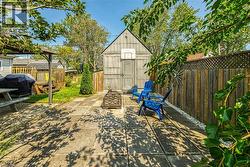 View of patio / terrace shed with fire wood storage at side - 