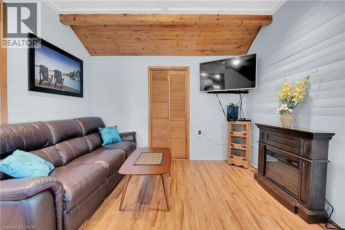 fans and electical lights included plus a 4 x 12 storage area off living room - 17 Maple Lane, Rainham, ON - Indoor Photo Showing Living Room With Fireplace