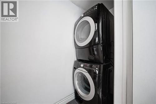 Laundry area with estacked washer and dryer - 276 Lakeshore Road W, Oakville, ON - Indoor Photo Showing Laundry Room