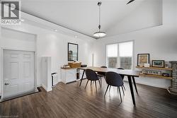 Office space featuring dark wood-type flooring, recessed lighting, and high vaulted ceiling - 