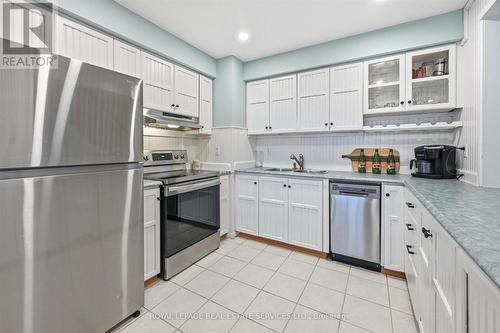 The Kitchen Offers an Abundance of White Cabinetry - 51 - 26 Moss Boulevard, Hamilton, ON - Indoor Photo Showing Kitchen With Stainless Steel Kitchen