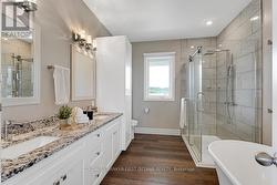 Primary suite ensuite two-sink granite vanity - 