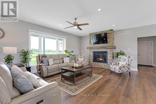 Living room stone fireplace with propane insert - 800 Waba Road, Mississippi Mills, ON - Indoor Photo Showing Living Room With Fireplace