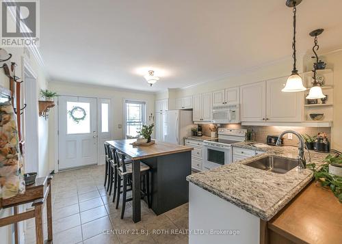 Quartz countertop, tile backsplash - 204 - 43 Creighton Street, Ramara, ON - Indoor Photo Showing Kitchen With Double Sink