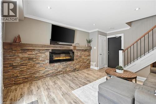 Fireplace ""flame"" is AI generated - 469 Claridge Road Unit# 6, Burlington, ON - Indoor Photo Showing Other Room With Fireplace