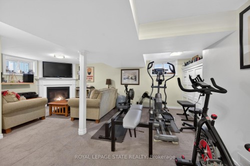 13 Cameron Avenue, Hamilton, ON - Indoor Photo Showing Gym Room With Fireplace
