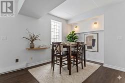 Dining room with existing table, virtually staged. - 