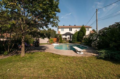 Face arrière - 306 Rue De Normandie, Sainte-Julie, QC - Outdoor With In Ground Pool