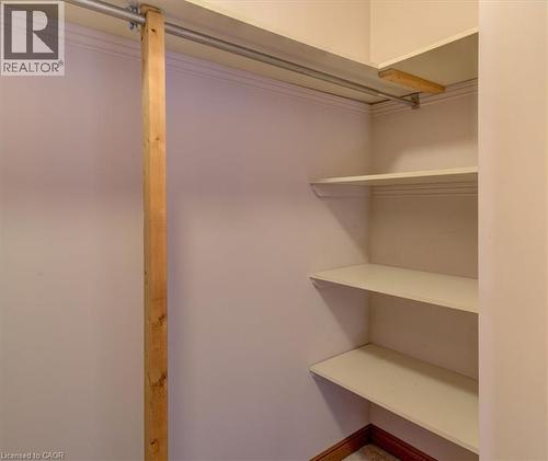 Smartly designed, the primary closet offers built-in shelving and ample room for your wardrobe. - 42 Donly Drive S Unit# 2, Simcoe, ON - Indoor With Storage