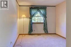 Upper North-East Bedroom 2: This cozy bedroom features soft carpet and charming wood trim, perfect for relaxation and quiet mornings. - 