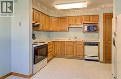 This kitchen comes ready to serve, fully equipped with all appliances and room for family dinners. - 