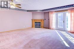 Spacious living area with a cozy gas fireplace, perfect for family gatherings, and access to your sunny deck. - 