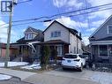 View of front facade with covered porch - 14 Carlisle Street, Hamilton, ON  - Outdoor With Facade 