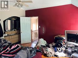 Bedroom with parquet floors, ceiling fan, and a textured ceiling - 