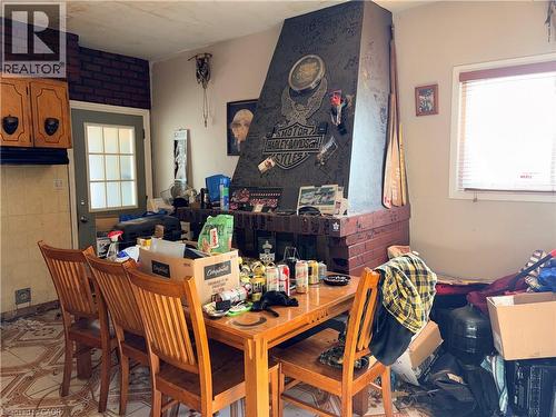 Dining room featuring light floors and brick wall - 14 Carlisle Street, Hamilton, ON - Indoor