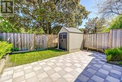Tranquil side yard shaded by mature trees - 
