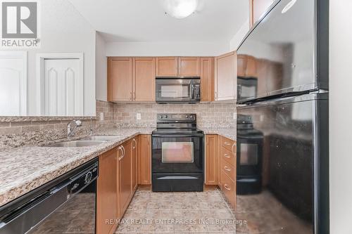 Kitchen with Ample Storage and Counter Space - 1420 - 8 Dayspring Circle, Brampton, ON - Indoor Photo Showing Kitchen With Double Sink