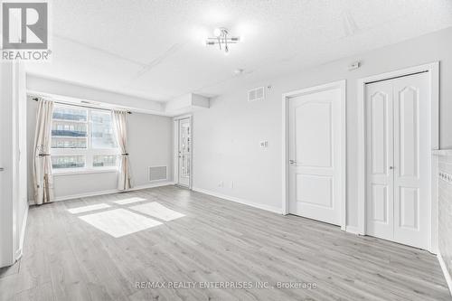 Living Room features walkout to covered balcony - 1420 - 8 Dayspring Circle, Brampton, ON - Indoor Photo Showing Other Room