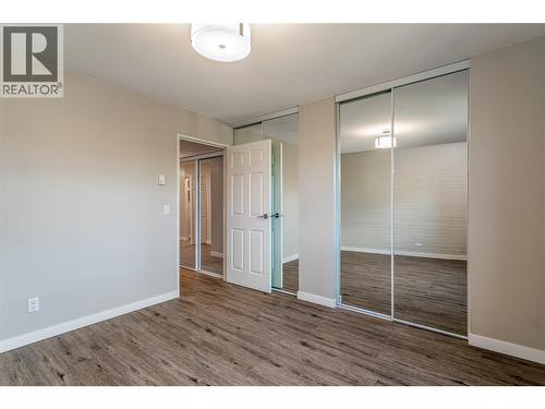 Primary bedroom with dual closets - 1915 Pacific Court Unit# 407, Kelowna, BC - Indoor Photo Showing Other Room