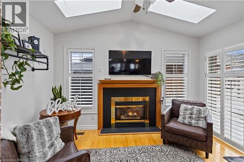 Cozy sitting room with vaulted ceilings, skylights and NG fireplace - 12 Falls Crescent, Simcoe, ON - Indoor Photo Showing Living Room With Fireplace