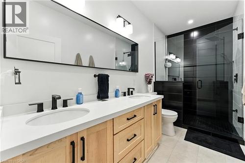 Full bath with double vanity, a stall shower, recessed lighting, and light tile patterned floors - 9 Macneil Court, Port Burwell, ON - Indoor Photo Showing Bathroom