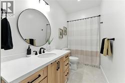 Bathroom featuring vanity, a shower with shower curtain, and light tile patterned floors - 