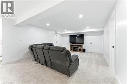 Living area featuring light colored carpet and recessed lighting - 